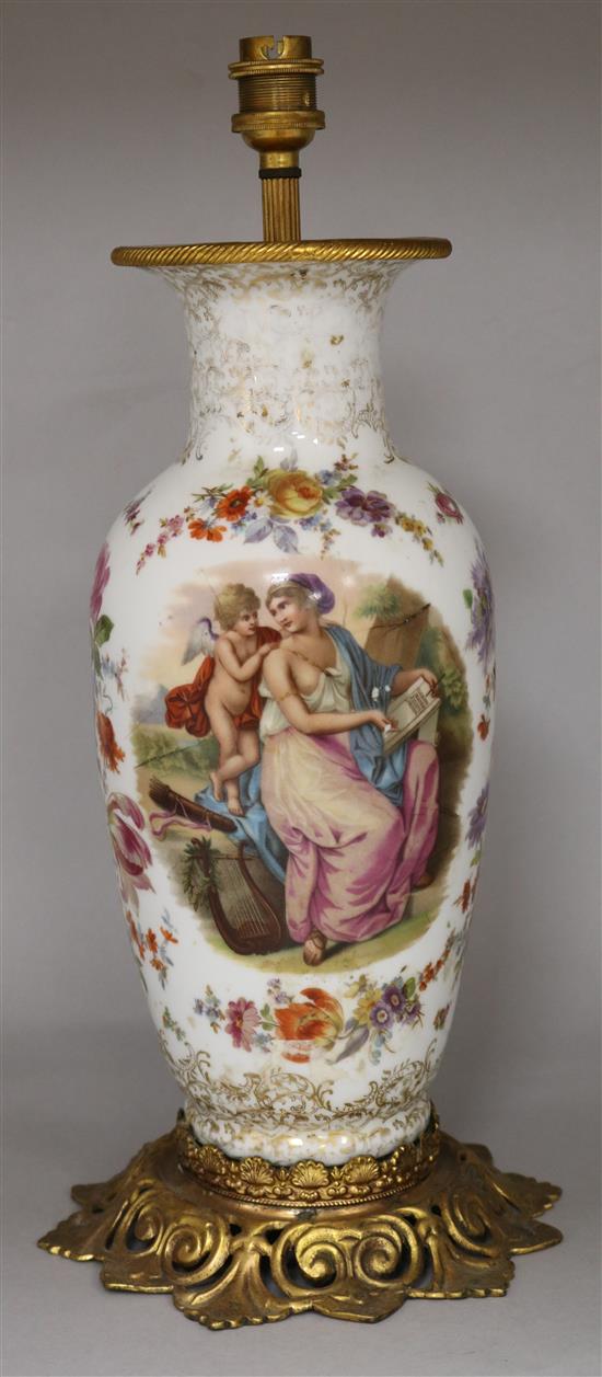A floral painted ovoid shaped porcelain table lamp, with pierced ormolu plinth